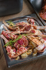 Rack of Lamb, raw, prepared for grilling. Blanks for restaurant and catering, with a sprig of rosemary on top.