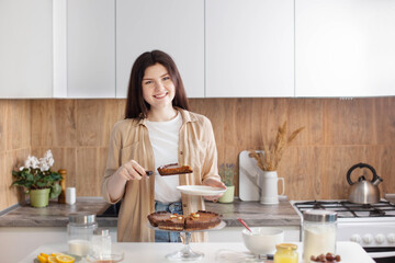 Obraz na płótnie Canvas teen girl with nuts pie in kitchen