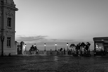 People enjoying the nightfall in Praça Tomé de Souza, postcard of the historic center of...