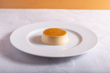 Caramel panna cotta on white background