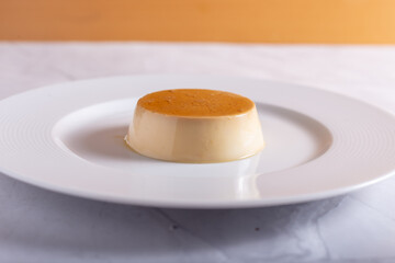 Caramel panna cotta on white background