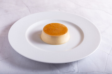 Caramel panna cotta on white background