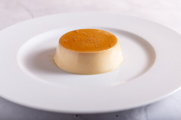 Caramel panna cotta on white background