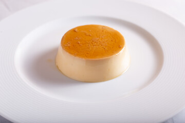 Caramel panna cotta on white background