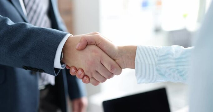 Closeup of business partners shaking hands in office 4k movie slow motion