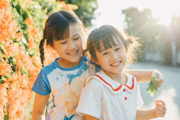 People portrait of an emotional face expression of smiling and laughing of 6 year old Asian sibling...