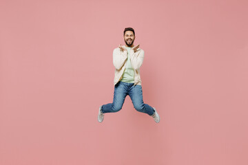 Fototapeta na wymiar Full body young surprised overjoyed exultant jubilant happy fun man 20s wearing trendy jacket shirt jump high hold face isolated on plain pastel light pink background studio. People lifestyle concept.
