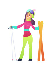 Beautiful girl with purple hair in bright ski suit holds skis with poles and smiles