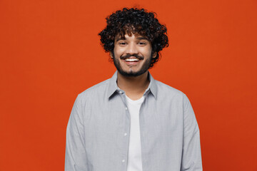 Smiling fascinating cheerful blithesome young bearded Indian man 20s years old wears blue shirt...