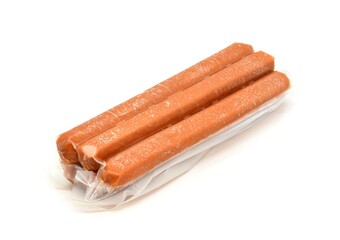 A pack of sausages (hot dogs) in a vacuum foil placed on a white background.