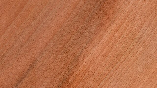 Close-up top view flat lay 4k stock video footage of brown organic real wood texture with natural line and scrapes prom polishing instrument work. Abstract natural brown wooden background