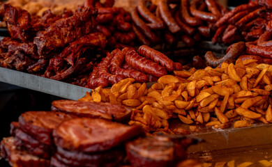 Piles of Meat and  Potato Wedges at Christmas Traditional Food Market Fair in Timisoara, Romania