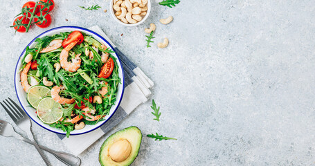 Shrimps salad with tomato, arugula, avocado and cashew nuts