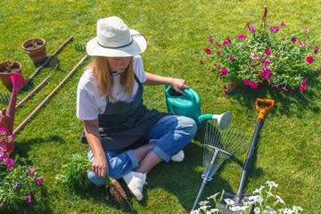 Garden,gardening home. Girl replanting green pasture in home garden.agriculture,indoor garden,room with plants banner Potted green plants at home, home jungle,Garden room gardening, Plant room