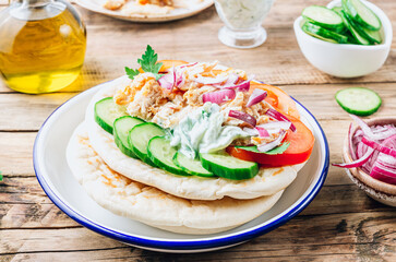 Healthy diet Gyros, greek pita bread wrapped sandwich with meat slices, tzatziki and fresh vegetables.