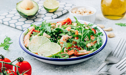 Shrimps salad with tomato, arugula, avocado and cashew nuts