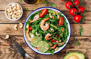 Shrimps salad with tomato, arugula, avocado and cashew nuts