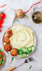 Turkey patties served with mashed potato and fresh salad