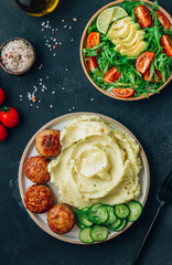 Turkey patties served with mashed potato and fresh salad