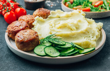 Turkey patties served with mashed potato and fresh salad