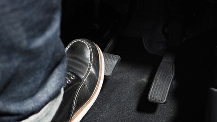 Accelerate and Brake. Foot pressing foot pedal of a car to drive ahead. Accelerator and brake pedal...