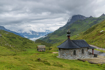 Bruder Klaus chapel, Typical alpine landscape of Swiss Alps near Klausenstrasse, Spiringen, Canton...