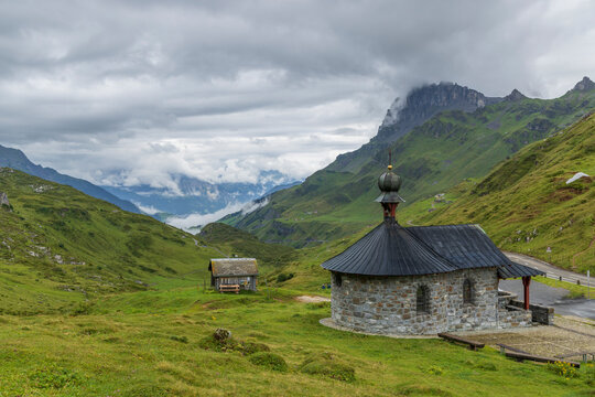 Bruder Klaus chapel, Typical alpine landscape of Swiss Alps near Klausenstrasse, Spiringen, Canton of Uri, Switzerland