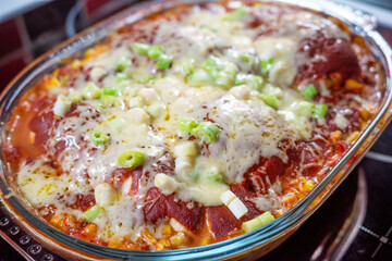 Close up of a homemade or homecooked chicken and cheese enchilada bake