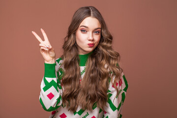 Fototapeta premium Portrait of a young beautiful teenage girl on a beige isolated background