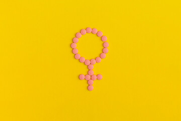 Female sign on yellow background. Top view. Flat lay.