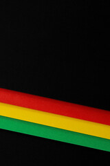 Black History Month color background. African American history month celebration. Abstract red, yellow, green color flag on black paper background