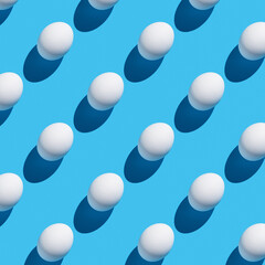 The pattern of their white eggs with a hard shadow on a blue background.