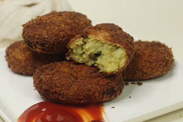 Deep fried Chicken Cutlets. A flat croquette of minced meat covered in bread crumbs and fried