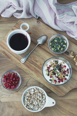 Healthy breakfast with yogurt, nuts, cereals and pomegranate seeds. Healthy snack packed with vitamins and antioxidants
