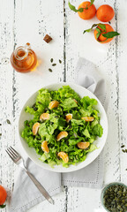 Lettuce salad with tangerines, olive oil, pumpkin seeds