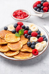 Keto pancakes made of diet flour or almond flour, served with berries.