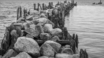an old pier made of stones and wood