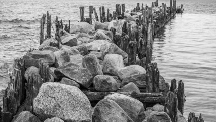 an old pier made of stones and wood