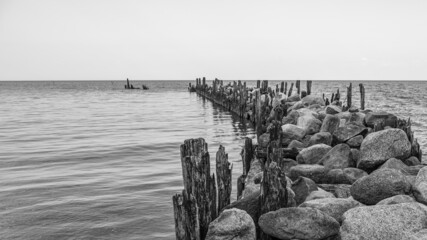 an old pier made of stones and wood
