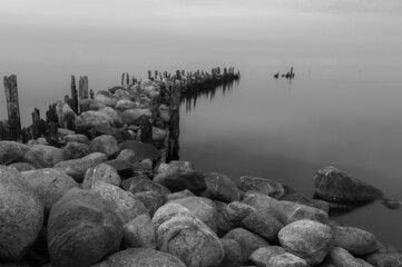 an old pier made of stones and wood