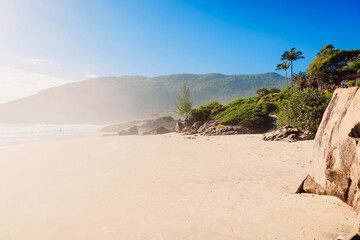 Matadeiro beach with morning fog, rocks and ocean in sunny day. Holiday banner in Brazil