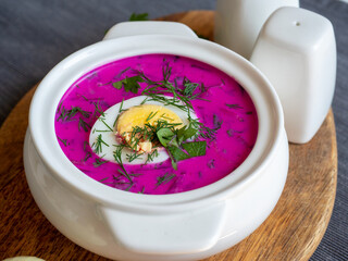Close-up of cold chlodnik soup on a wooden board. Soup of Polish Belarusian and Russian cuisine...