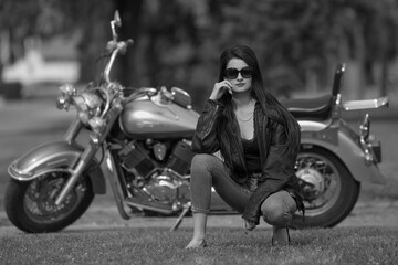 Fototapeta na wymiar Portrait of young woman on motorcycle