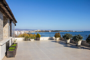 Balcony overlooking the sea. Relaxation area on a large modern terrace in a new building on the first line with panoramic sea views.  Luxury vacation rental. Overseas property on the sea coast.