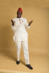 Yoruba Culturally Dressed Business Man leaning backwards in shock with hands out