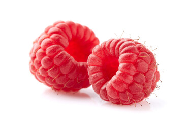 Two raspberries in closeup on white background