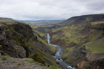 Fototapeta premium Green Grassy mountain Landscape in the highlands. Travel and nature on a beautiful cold day