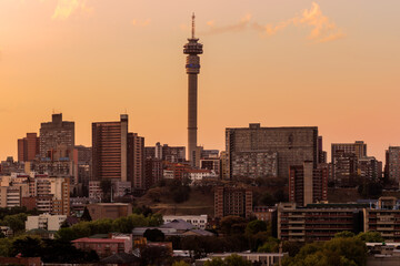 A horizontal panoramic cityscape taken at sunset, of the central business district of the city of Johannesburg, South Africa