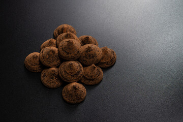 Chocolate truffles on a black background.