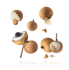 Fresh raw longan fruit falling in the air isolated on white